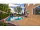 Lush backyard featuring a private pool with sun-drenched patio, adjacent to a spacious home exterior at 1513 Ravanusa Dr, Henderson, NV 89052