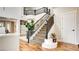 Elegant staircase with a dark wood railing, carpeted steps, and a view of the upper level landing at 1513 Ravanusa Dr, Henderson, NV 89052