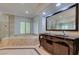 Luxurious primary bathroom with soaking tub, walk-in shower, and dual vanities at 1813 Francisco Peak Pl, Las Vegas, NV 89128