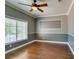 Bedroom with hardwood floors, large window, two tone paint, and classic trim at 1813 Francisco Peak Pl, Las Vegas, NV 89128