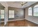 Bedroom with ceiling fan, hardwood floors, and a mirrored closet door at 1813 Francisco Peak Pl, Las Vegas, NV 89128