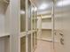 A walk-in closet with custom shelving and glass door storage cabinets offering ample space at 1813 Francisco Peak Pl, Las Vegas, NV 89128