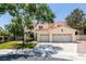 Charming two-story home with a three-car garage, tiled roof, and a well-manicured front lawn, perfect for suburban living at 1813 Francisco Peak Pl, Las Vegas, NV 89128