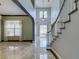 Bright, open foyer leading into the living room, featuring a staircase and high ceilings at 1813 Francisco Peak Pl, Las Vegas, NV 89128