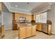 Kitchen with custom cabinets, an island, granite countertops, and stainless steel appliances at 1813 Francisco Peak Pl, Las Vegas, NV 89128