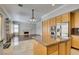 View of the kitchen and living room showing granite counters, stainless appliances, and fireplace at 1813 Francisco Peak Pl, Las Vegas, NV 89128