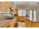Open kitchen with custom cabinets, granite countertops, gas cooktop, and stainless appliances at 1813 Francisco Peak Pl, Las Vegas, NV 89128