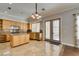 Bright kitchen with custom cabinets, stainless steel appliances, an island, and backyard access at 1813 Francisco Peak Pl, Las Vegas, NV 89128