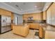 Kitchen with custom cabinets, an island, granite countertops, and stainless steel appliances at 1813 Francisco Peak Pl, Las Vegas, NV 89128