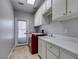 Laundry room with a modern washer and dryer, sink and tile floors at 1813 Francisco Peak Pl, Las Vegas, NV 89128