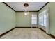 Bright, open living room featuring a decorative chandelier, tile floors, and large windows for ample sunlight at 1813 Francisco Peak Pl, Las Vegas, NV 89128