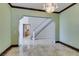 Spacious living room with marble flooring, chandelier, and a seamless transition to the foyer and staircase at 1813 Francisco Peak Pl, Las Vegas, NV 89128
