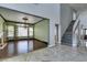 Elegant living room featuring hardwood floors, high ceilings, a fireplace, and an ornate chandelier at 1813 Francisco Peak Pl, Las Vegas, NV 89128