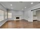 Open living room with fireplace and light-colored walls and hardwood floors at 1813 Francisco Peak Pl, Las Vegas, NV 89128