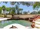 Swimming pool with rock waterfall feature and backyard landscaping at 1813 Francisco Peak Pl, Las Vegas, NV 89128