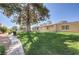 Expansive backyard with lush lawn, mature trees, and neutral exterior, perfect for outdoor enjoyment at 1857 Arbol Verde Way, Las Vegas, NV 89119