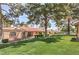 Image displays well-maintained lawn, mature trees, and neutral-colored exterior, creating a serene outdoor living space at 1857 Arbol Verde Way, Las Vegas, NV 89119
