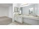 Bright bathroom with marble countertop, large mirror, and tile floor at 1857 Arbol Verde Way, Las Vegas, NV 89119