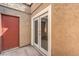 Exterior view showing a stucco wall, door and glass doors to patio at 1857 Arbol Verde Way, Las Vegas, NV 89119