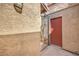 Exterior shot of stucco wall, gate and a red door at 1857 Arbol Verde Way, Las Vegas, NV 89119