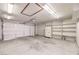 Spacious garage with shelving, refrigerator, and a two car door at 1857 Arbol Verde Way, Las Vegas, NV 89119