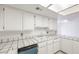 Well-lit kitchen featuring white cabinetry and tile countertops at 1857 Arbol Verde Way, Las Vegas, NV 89119
