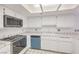 Bright kitchen with white cabinets, stainless steel microwave, and tile countertops at 1857 Arbol Verde Way, Las Vegas, NV 89119
