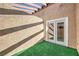 Enclosed patio featuring artificial turf and stucco walls under a pergola at 1857 Arbol Verde Way, Las Vegas, NV 89119