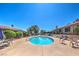 Community pool with various seating and tables available for residents to enjoy at 1857 Arbol Verde Way, Las Vegas, NV 89119