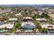 A neighborhood aerial view with a home that has a backyard pool and solar panels on the roof at 2209 Purple Majesty Ct, Las Vegas, NV 89117