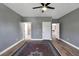Spacious gray bedroom with wood-look flooring, ceiling fan, and neutral walls at 2209 Purple Majesty Ct, Las Vegas, NV 89117
