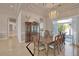 Dining room featuring a large table set for eight, chandelier, and natural light at 2209 Purple Majesty Ct, Las Vegas, NV 89117