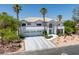Stunning two-story home with a three-car garage and palm trees in a well-manicured front yard at 2209 Purple Majesty Ct, Las Vegas, NV 89117