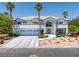 This home has a three-car garage, well-manicured landscaping, and great curb appeal at 2209 Purple Majesty Ct, Las Vegas, NV 89117