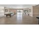 Spacious living room featuring a pool table, bar area, and sliding glass doors to the outside at 2209 Purple Majesty Ct, Las Vegas, NV 89117