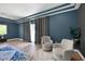 Seating area of the main bedroom with gray walls, hardwood floors, area rug, and natural light at 2209 Purple Majesty Ct, Las Vegas, NV 89117