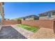 Brick-fenced backyard features pavers, gravel, and strip of turf with planters at 3164 Bormida Ave, Henderson, NV 89044