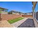 Brick-fenced backyard featuring pavers, gravel, and planters with strip of turf at 3164 Bormida Ave, Henderson, NV 89044