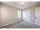 Neutral bedroom features carpet flooring and closet space with white doors at 3164 Bormida Ave, Henderson, NV 89044