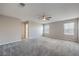 Bedroom with a ceiling fan, neutral walls, carpet flooring, and two windows at 3164 Bormida Ave, Henderson, NV 89044