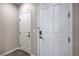 Home entryway featuring a storm door, white interior doors, and wood flooring at 3164 Bormida Ave, Henderson, NV 89044