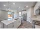 Bright kitchen area with stainless appliances, large island, and seamless access to outdoor patio at 3164 Bormida Ave, Henderson, NV 89044