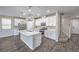 Modern kitchen featuring an island, stainless appliances, and seamless access to staircase at 3164 Bormida Ave, Henderson, NV 89044