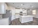 Bright kitchen featuring an island with a marble countertop and stainless steel appliances at 3164 Bormida Ave, Henderson, NV 89044