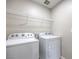 The laundry room is equipped with a Whirlpool washer and dryer with white shelving at 3164 Bormida Ave, Henderson, NV 89044