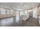 Open concept living area featuring stainless appliances, kitchen island, and hardwood floors at 3164 Bormida Ave, Henderson, NV 89044