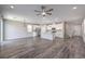Open-concept living space with modern lighting, wood floors, and a combined kitchen at 3164 Bormida Ave, Henderson, NV 89044
