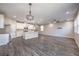 Open-concept living space with modern lighting, wood floors, and a combined kitchen at 3164 Bormida Ave, Henderson, NV 89044
