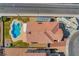 A bird's-eye view of a backyard oasis featuring a freeform pool and spa with easy access to a nearby street at 3937 Country Lights St, Las Vegas, NV 89129