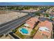 Aerial view of a home showing a private pool, patio, and proximity to a major highway in a residential neighborhood at 3937 Country Lights St, Las Vegas, NV 89129
